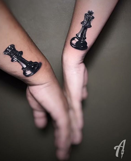 queen chess piece tattoo on wrist